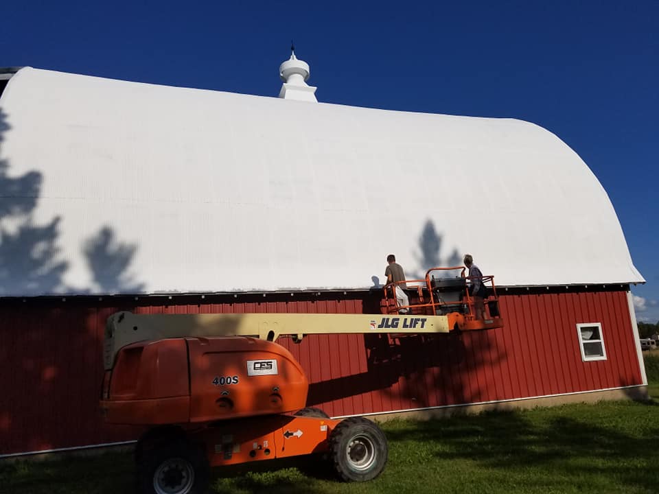 Roof coating on classic red barn